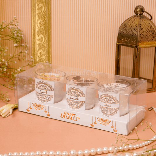 Three candles in a decorative box with 'Happy Diwali' text 